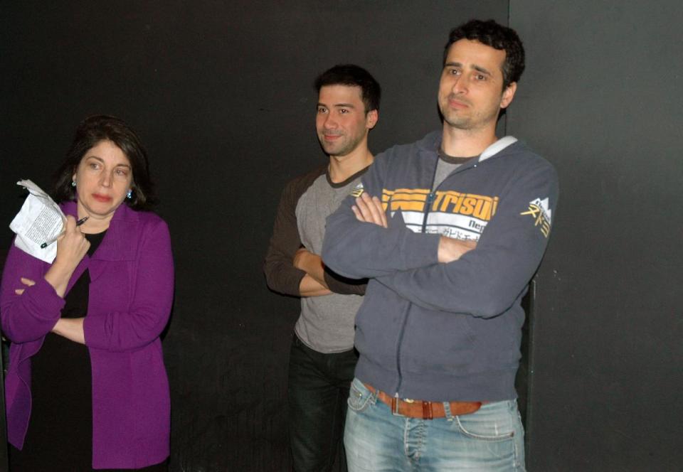 This Feb. 9, 2014 photo shows, from left, Anne D’Innocenzio, with her classmates Erik Ramos and Oren Harnevo listening to directions before a standup comedy show at Caroline's Comedy Club in New York after taking a six-week class in standup comedy. The $395 course, held at a nearby acting studio, culminates with a graduation performance at the club for friends and family. (AP Photo/Lawrence Roberts)