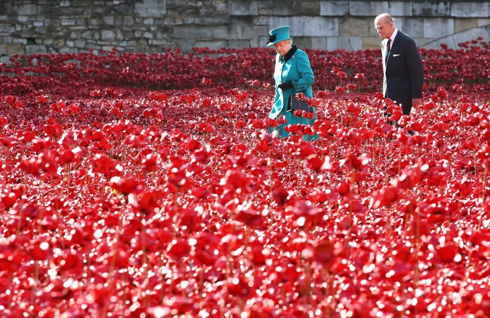 Queen Elizabeth II and Prince Philip, Duke of Edinburgh visit the Blood Swept Lands and Seas of Red evolving art installation at the Tower of London, 2014 (Getty)
