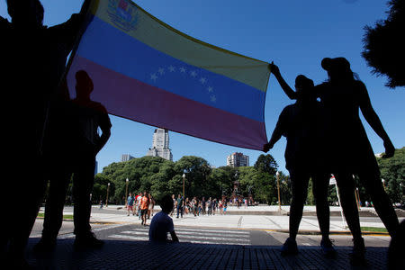 Venezuelan residents in Argentina and pro-government supporters display their national flag in Buenos Aires, Argentina April 1, 2017. REUTERS/Martin Acosta