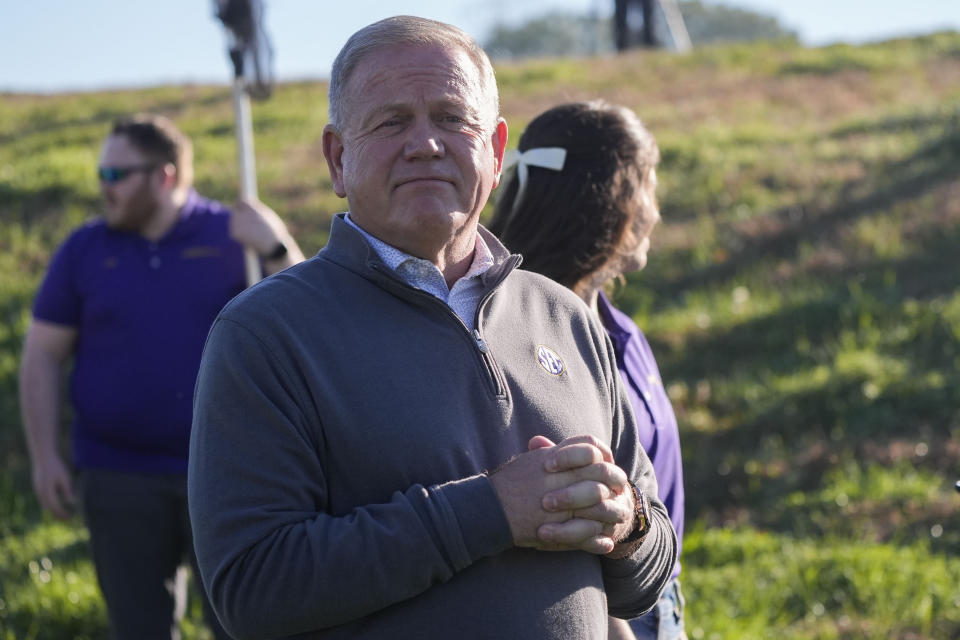 LSU head football coach Brian Kelly watches after ceremonially helping release a bald eagle, that was treated by the LSU School of Veterinary Medicine's Wildlife Hospital, along the Mississippi River in Baton Rouge, La., Friday, Feb. 2, 2024. Radiographs showed she had a left coracoid fracture. The coracoid bone is important for birds because it helps them with flight. Faculty, staff, and students at LSU Vet Med provided her with pain relief and cage rest, and is now fully flighted. (AP Photo/Gerald Herbert)