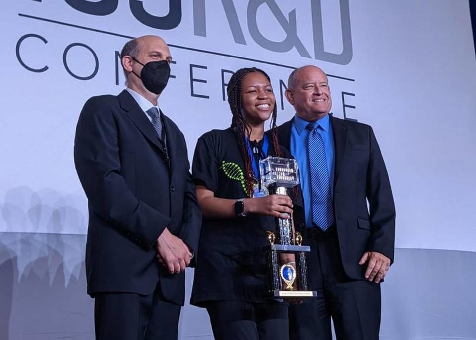 Pristine Onuoha holds her trophy alongside Ezequiel Alvarez Saavedra, co-founder of Genes in Space (left), and Scott Copeland, the Director of ISS Research Integration at Boeing at the ISS Research & Development Conference in Washington, D.C. on July 28, 2022. As the winner, the East Chapel Hill High School student’s experiment will be conducted at the International Space Station in 2023.