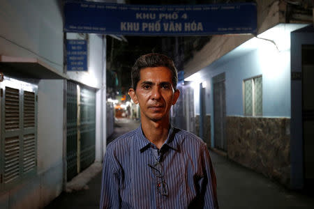 Vietnamese deportee and Amerasian Pham Chi Cuong, 47, who was deported from the U.S., poses outside his former house, where he lived before fled to the U.S., in central Ho Chi Minh City, Vietnam April 20, 2018. REUTERS/Kham