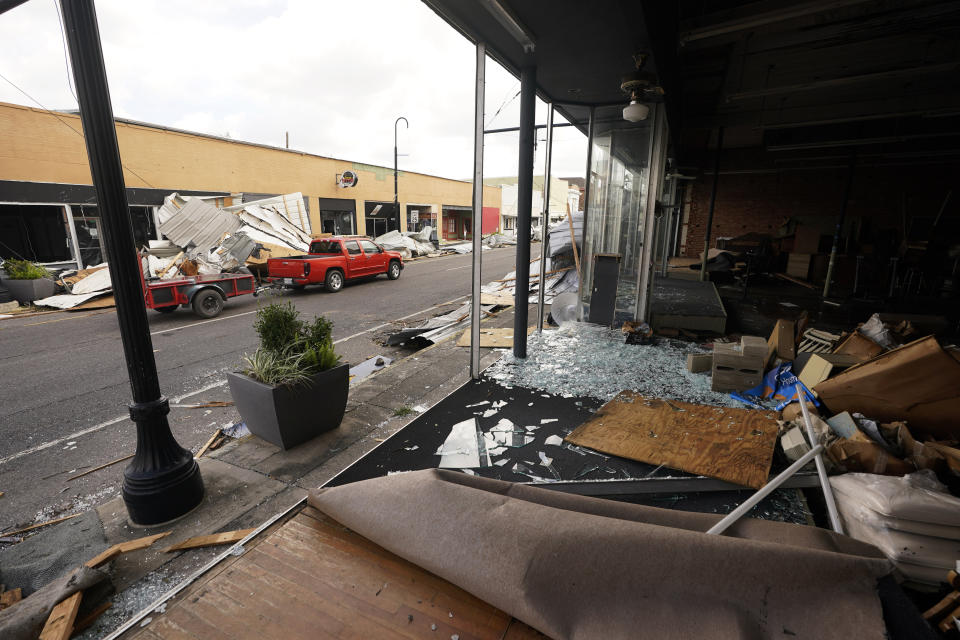 Traffic passes the front of a blown out storefront on Main Street in downtown as residents and try to recover from the effects of Hurricane Ida Tuesday, Aug. 31, 2021, in Houma, La. (AP Photo/Steve Helber)