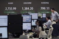 Currency traders watch monitors near the screen showing the Korea Composite Stock Price Index (KOSPI), top left, and the foreign exchange rate between U.S. dollar and South Korean won, top center, at the foreign exchange dealing room of the KEB Hana Bank headquarters in Seoul, South Korea, Wednesday, July 31, 2024. (AP Photo/Ahn Young-joon)