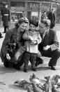 <p>Charles Robert Watts aged 2 with his mother Lillian and father Charles in Piccadilly Circus in 1943.</p>