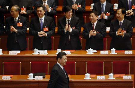 Delegates clap as China's President Xi Jinping (front) arrives for the closing ceremony of Chinese National People's Congress (NPC) at the Great Hall of the People, in Beijing, in this March 13, 2014 file photo. REUTERS/Kim Kyung-Hoon/Files