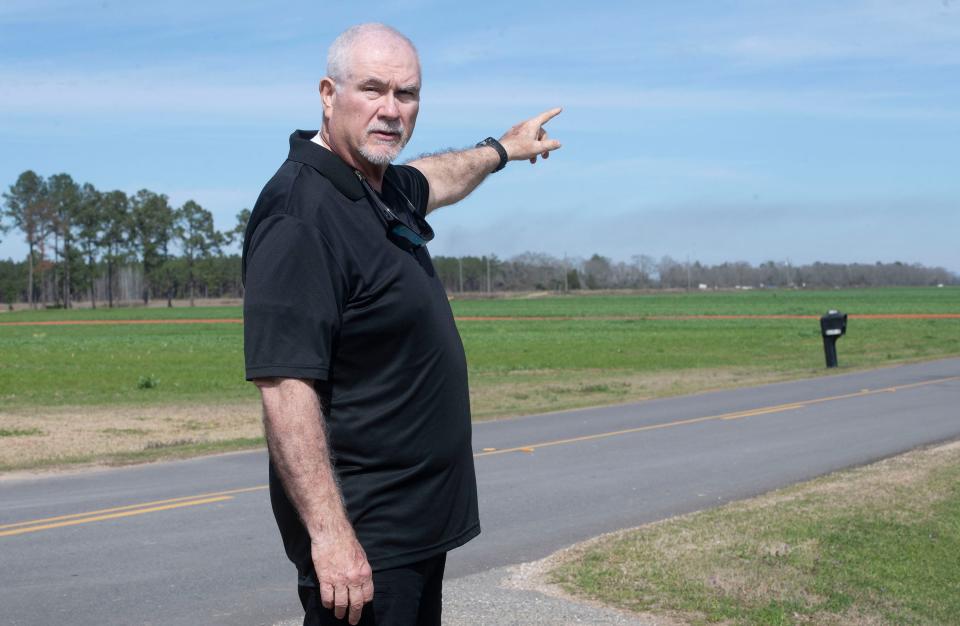 Ben Davis points out an air ambulance's landing zone on the long rural road in front of their Walnut Hill home on Thursday, Feb. 15, 2024. Davis nearly lost his life 15 months ago after what he said was a lengthy delay by ambulance crews.
