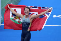 Gold medalist Flora Duffy of Bermuda celebrates after winning the women's individual triathlon competition at the 2020 Summer Olympics, Tuesday, July 27, 2021, in Tokyo, Japan. (AP Photo/David Goldman)