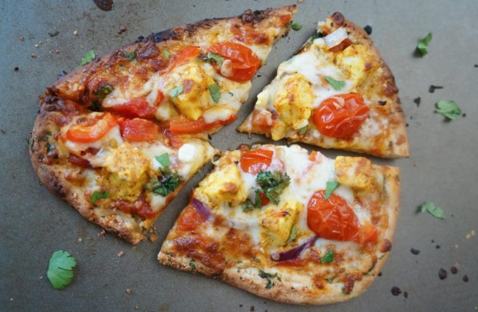 <p>Piping Pot Curry</p><p>Tandoori Paneer Naan Pizza is made with marinated paneer, red peppers, onions and grape tomatoes in an air fryer.</p><p><strong>Get the recipe here: <a href="https://pipingpotcurry.com/tandoori-paneer-naan-pizza-air-fryer-oven/" rel="nofollow noopener" target="_blank" data-ylk="slk:Tandoori Paneer Naan Pizza;elm:context_link;itc:0;sec:content-canvas" class="link ">Tandoori Paneer Naan Pizza</a></strong></p><p><strong>Related: <a href="https://parade.com/843981/manuzangara/17-indian-street-food-recipes/" rel="nofollow noopener" target="_blank" data-ylk="slk:17 Indian Street Food Recipes;elm:context_link;itc:0;sec:content-canvas" class="link ">17 Indian Street Food Recipes</a></strong></p>