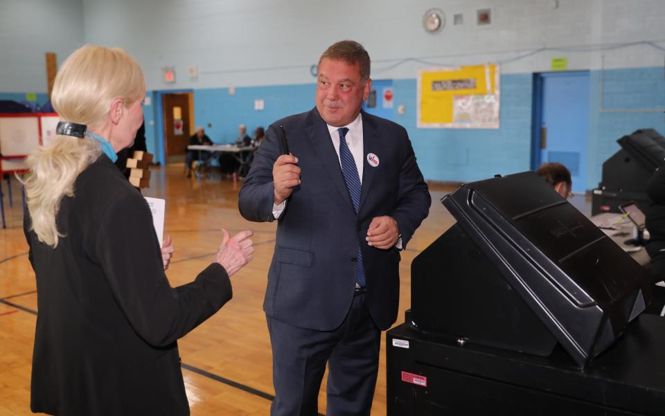 Yonkers Mayor Mike Spano completes casting his ballot as election worker Wendy Schildwachter looks on, at the Khalil Gibran School in Yonkers on Election Day, Nov. 7, 2023.