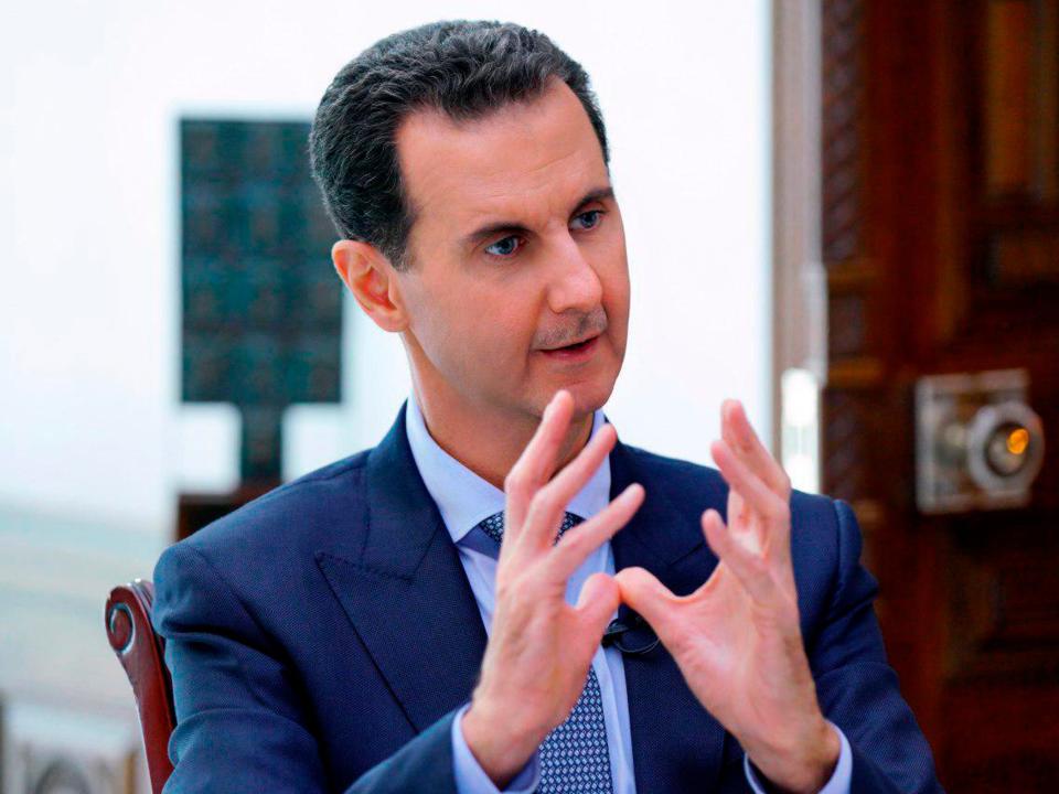 In this photo released by the Syrian official news agency SANA, Syrian President Bashar Assad speaks during an interview with Russia24 TV and Rossiya Segodnya news agency, in Damascus, Syria, Friday, Nov. 15, 2019. Assad said the American presence in Syria will lead to armed "resistance" that will eventually force the U.S. troops to leave. (SANA via AP)