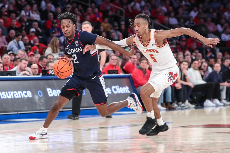 Connecticut guard Tristen Newton (2) drives past St. John's guard Daniss Jenkins during their game at Madison Square Garden.