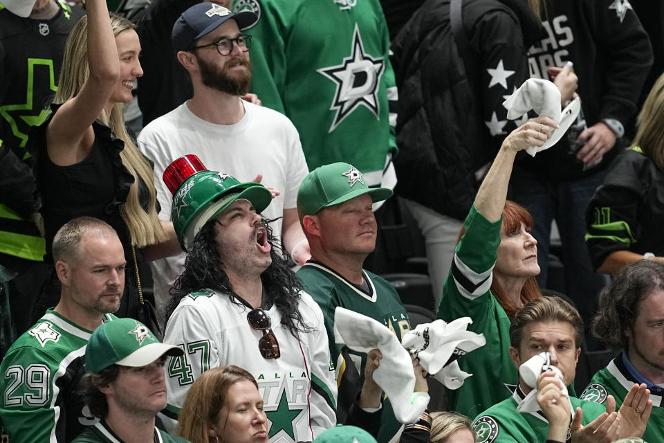 Spectators react during the third period in Game 5 of an NHL hockey Stanley Cup second-round playoff series between the Dallas Stars and the Colorado Avalanche, Wednesday, May 15, 2024, in Dallas. (AP Photo/Tony Gutierrez)
