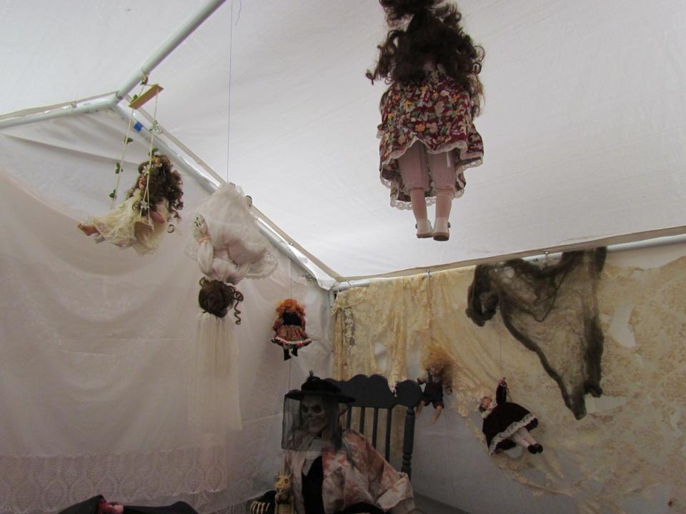 Dolls hanging from the ceilling inside one of the rooms at the Foundry's interactive haunted house on Sept. 27, 2023