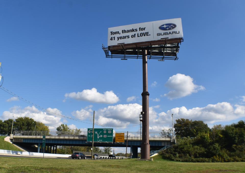 A billboard honoring a retired Subaru of America executive rises off Admiral Wilson Boulevard at South 11th Street in Camden.