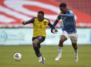 FILE - Ecuador's Renato Ibarra, left, battles for the ball with Colombia's Jefferson Lerma during a qualifying soccer match for the FIFA World Cup Qatar 2022 in Quito, Ecuador, Tuesday, Nov. 17, 2020. (Rodrigo Buendia, Pool via AP, File)