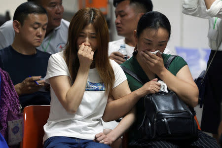 Relatives of Chinese tourists involved in a sunken tourist boat accident, cry at a hospital in Phuket, Thailand, July 7, 2018. (REUTERS)