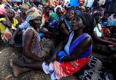 Women wait to receive aid at a camp for the people displaced in the aftermath of Cyclone Idai in John Segredo near Beira, Mozambique March 31, 2019. REUTERS/Zohra Bensemra