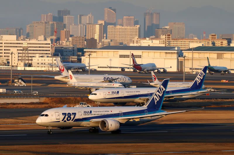 FILE PHOTO: ANA's Boeing 787 taxis in front of other aircraft at the Tokyo International Airport in Tokyo