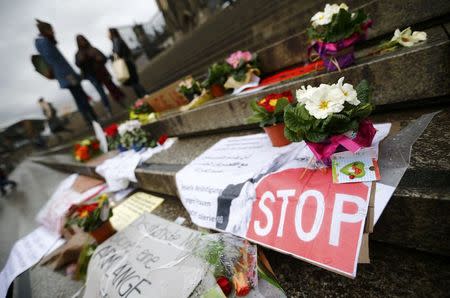 Flowers and posters are placed in the square between the city cathedral and the railway station in Cologne, Germany, January 11, 2016, where the vast majority of dozens of New Year Eve assaults on women took place. REUTERS/Wolfgang Rattay