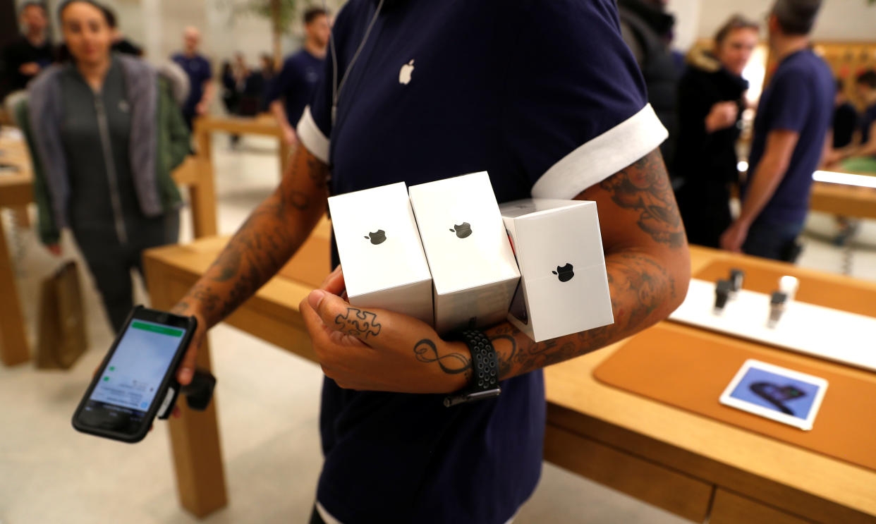 Cost of living An Apple Store staff shows Apple's new iPhones X after they go on sale at the Apple Store in Regents Street, London, Britain, November 3, 2017. REUTERS/Peter Nicholls