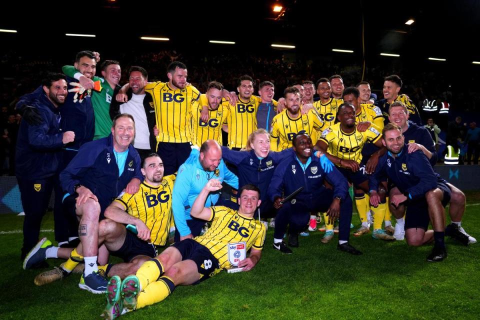 Oxford United's players and staff celebrate victory over Peterborough United in the play-offs <i>(Image: PA)</i>