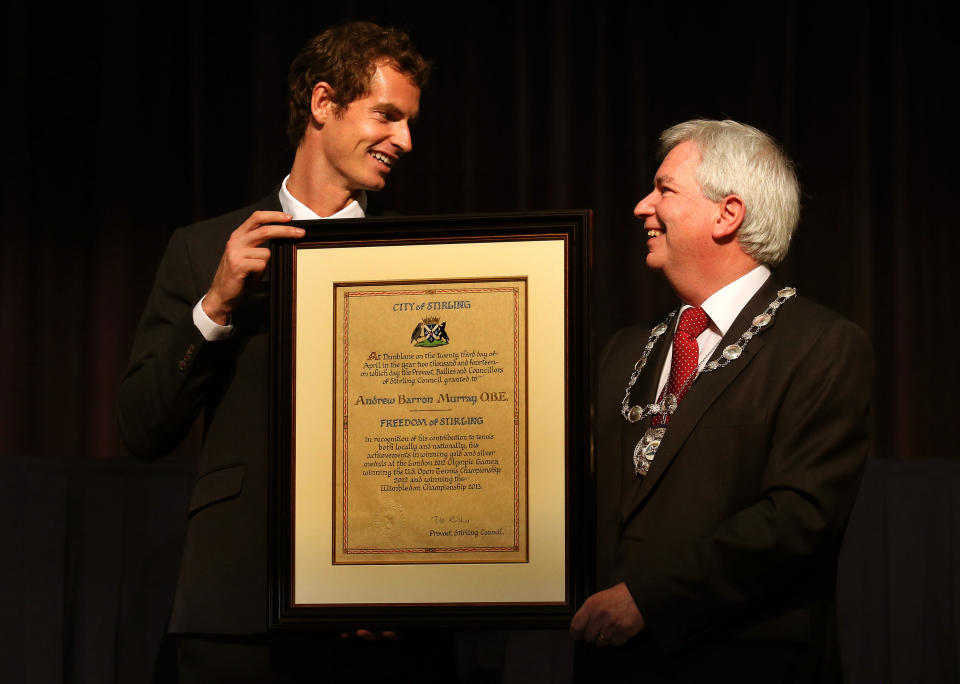 British tennis player Andy Murray, left, receives the Freedom of Stirling presented to him by Stirling Council Provost Mike Robbins during a special council meeting at his old school Dunblane High, in Dunblane, Scotland, Wednesday, April 23, 2014. Murray said he feels honored to receive the freedom of Stirling and an honorary degree from the university where he trained as a boy. (AP Photo/PA, Andrew Milligan) UNITED KINGDOM OUT, NO SALES, NO ARCHIVE