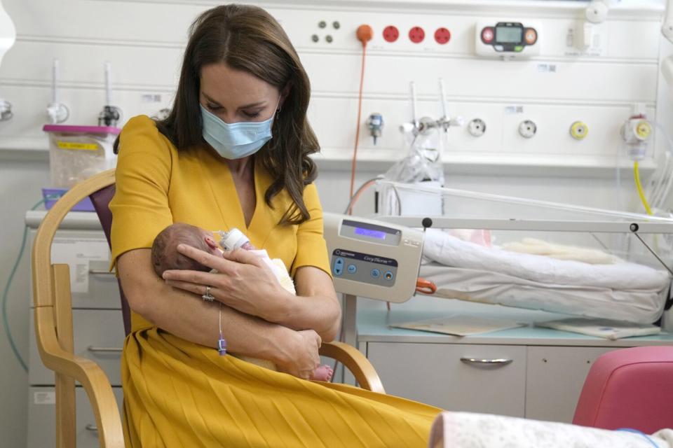 Catherine, Princess of Wales, left, speaks to Sylvia Novak while holding her daughter Bianca, during a visit to the maternity unit at Royal Surrey County Hospital