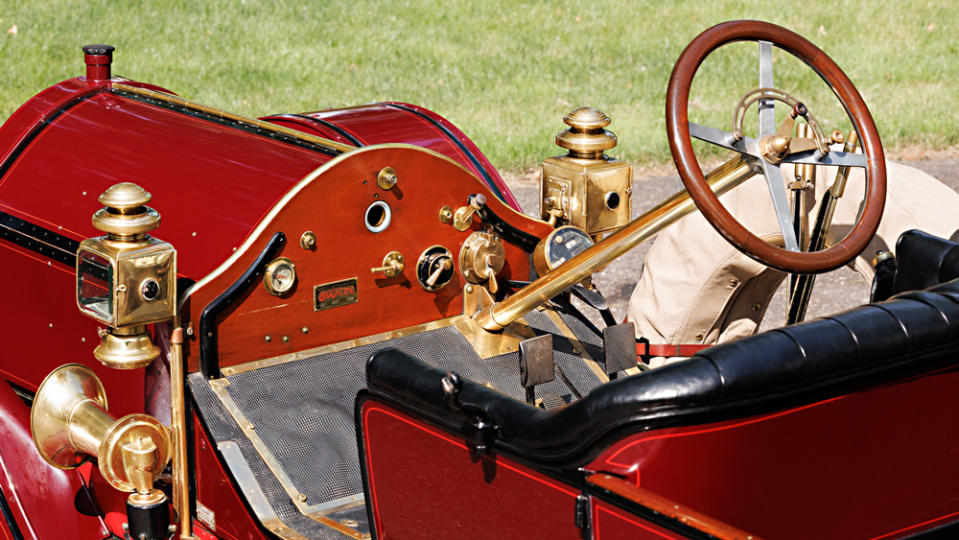 A close-up of the steering wheel and dashboard in a 1912 Simplex 50 HP Toy-Tonneau.