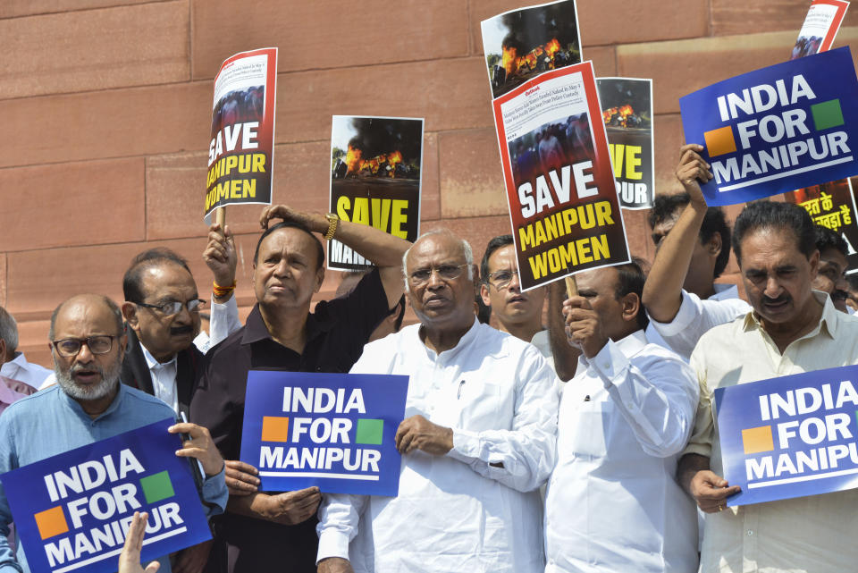 FILE - Opposition lawmakers demanding a statement from Prime Minister Narendra Modi on the violence in Manipur state carry placards outside the Parliament building in New Delhi, India, July 24, 2023. For three months, Indian Prime Minister Narendra Modi has been largely silent on ethnic violence that has killed over 150 people in Manipur, a remote state in India’s northeast. That's sparked a no-confidence motion against his government in Parliament, where his party and allies hold a clear majority. (AP Photo, File)