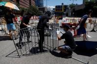 Protesters use barricades to block the road at the Cross-Harbour Tunnel in Hong Kong