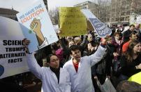 Neuroscientist Shruti Muralidhar, front left, and microbiologist Abhishek Chari, front right, hold placards and chant during a demonstration by members of the scientific community, environmental advocates, and supporters, Sunday, Feb. 19, 2017, in Boston. The scientists at the event said they want President Donald Trump's administration to recognize evidence of climate change and take action on various environmental issues. (AP Photo/Steven Senne)