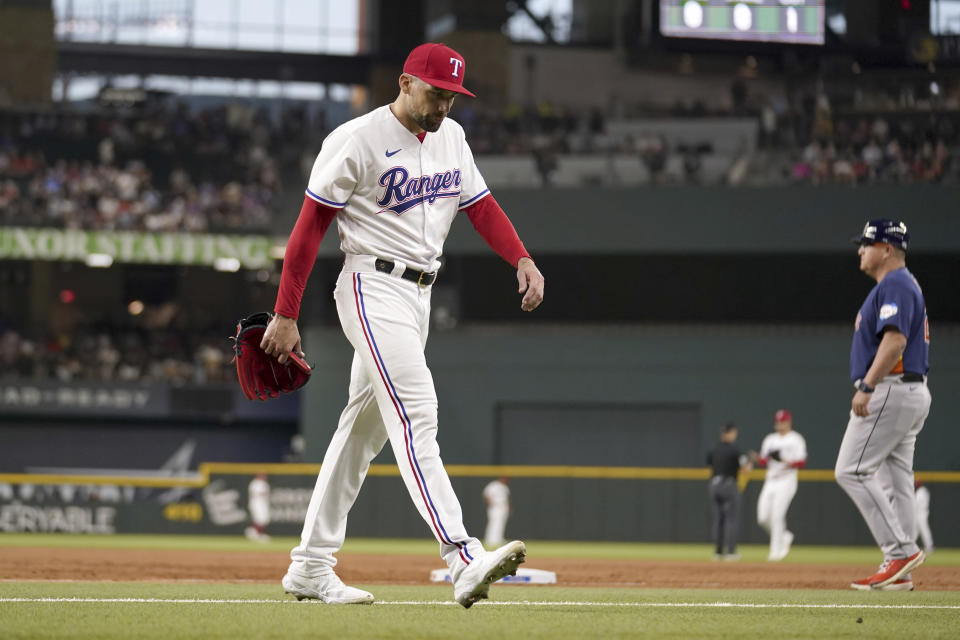 Texas Rangers starting pitcher Nathan Eovaldi walks off the field after being pulled in the second inning of a baseball game against the Texas Rangers, Tuesday, Sept. 5, 2023, in Arlington, Texas. (AP Photo/Tony Gutierrez)