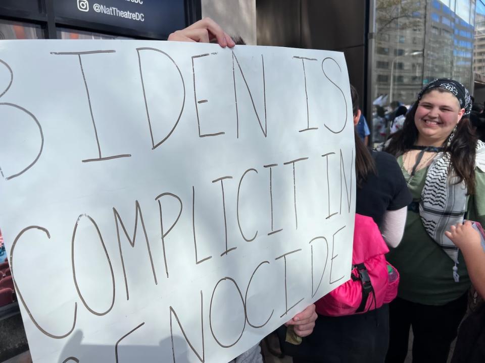 There were a number of anti-Biden signs at the protest in Washington. Summer Treece of Knoxville, Tenn., stands in the background behind one.