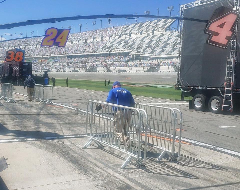 The prerace stages are being rolled to the grid, and security railing is being put in place as prerace work is well under way at Daytona.