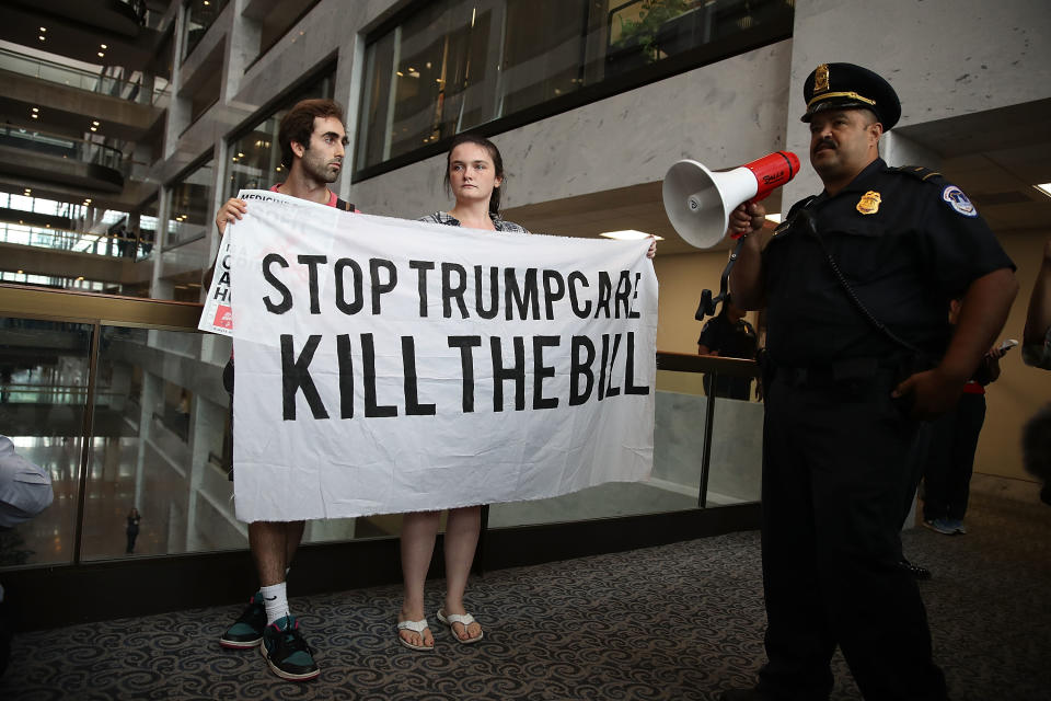 A U.S. Capitol Police officer asks protesters to leave the area around the office of Sen. Dean Heller, R-Nev., as they voice their opinion about the proposed health care bill in the Hart Senate Office Building on July 17, 2017, in Washington, D.C. Capitol Police arrested several protesters at various Senate offices as they asked senators to vote no on the Better Care Reconciliation Act. (Photo: Joe Raedle/Getty Images)