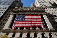 The U.S. flag covers the front facade of the NYSE in New York