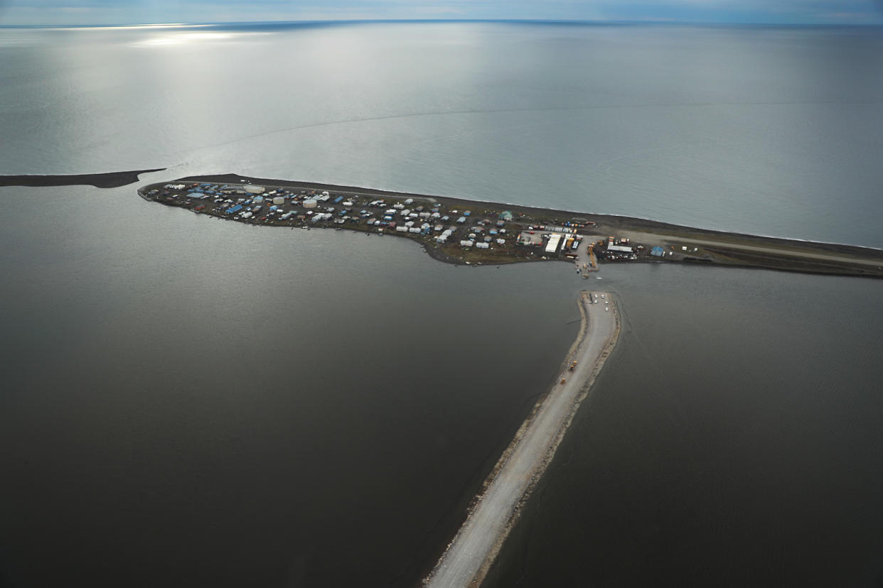 KIVALINA, ALASKA - SEPTEMBER 15:  An aerial view shows Kivalina, which is at the very end of an eight-mile barrier reef located between a lagoon and the Chukchi Sea on September 10, 2019 in Kivalina, Alaska. The road being built as an escape route for the village's people in case the ocean waters threatened is seen almost complete. The village is 83 miles above the Arctic circle. Kivalina and a few other native coastal Alaskan villages face the warming of the Arctic, which has resulted in the loss of sea ice that buffers the island’s shorelines from storm surges and coastal erosion. The residents of Kivalina are hoping to stay on their ancestral lands where they can preserve their culture, rather than dispersing due to their island being swallowed by the rising waters of the ocean.  City Administrator Colleen Swan says that the way of life in the village will change with the changing climate and they will adapt. In days gone by, they could migrate with the changes. But now, she says, with the magnitude of problem climate change brings, they must hope that the rest of the world reverses the trend, which she sees as being man-made, and save their way of life. (Photo by Joe Raedle/Getty Images)