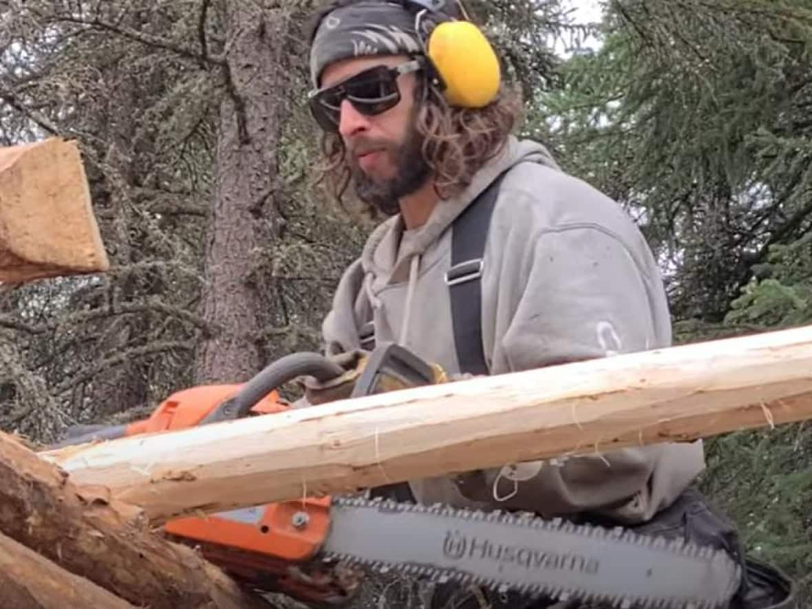 A still from a 2021 YouTube video posted by Matthew (Matty) Clarke, chronicling his efforts to build a log cabin in the Yukon wilderness near Dawson City. The territorial government filed a petition to the Yukon Supreme Court in March to force Clarke to leave the site at Ensley Creek and remove his cabin, saying Clarke built on public land with no legal authority. Clarke has agreed to dismantle the cabin and vacate the site by the end of the year. (Skote Outdoors/YouTube - image credit)