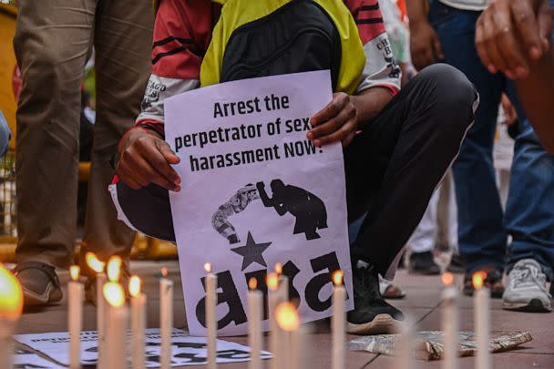 PHOTO: A person holds a placard during a Candlelight March called by India's Top Wrestlers against the allegations of sexual harassment to athletes by the Wrestling Federation of India (WFI) chief, in New Delhi on May 23, 2023. (Kabir Jhangiani/NurPhoto via Getty Images)