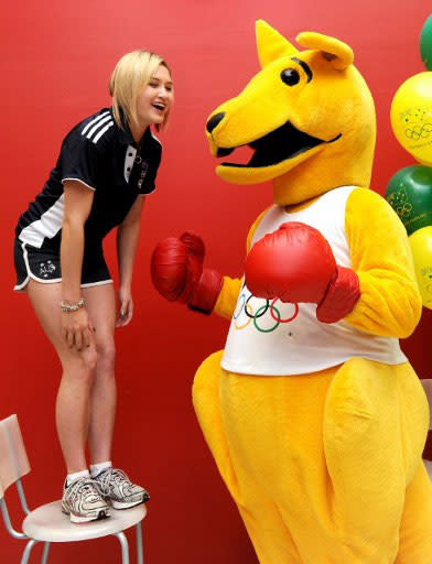 Australia's Beijing 2008 Olympic diving silver medallist Melissa Wu (L) talks to the Boxing Kangaroo as the Australian Olympic Committee (AOC) in Sydney on April 18, 2012 marks 100 days until the opening ceremony of the London 2012 Olympic Games. Australian Olympic team chief Nick Green said he remains confident of a top five finish in London despite a renewed threat from Britain, Japan, Germany and France. Green said Australia knows it will struggle to claim a place among the world's elite Olympic nations with the country set to send its smallest Games team in 20 years. AFP PHOTO / William WEST