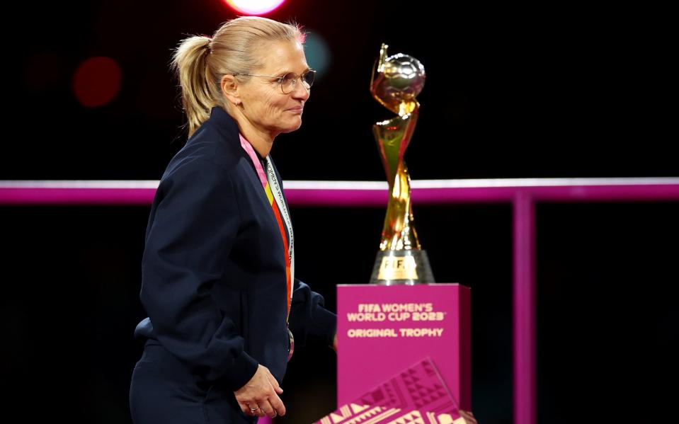 Sarina Wiegman, Head Coach of England, walks past the FIFA Women's World Cup Trophy during the award ceremony following the FIFA Women's World Cup Australia & New Zealand 2023 Final match between Spain and England at Stadium Australia on August 20, 2023 in Sydney, Australia
