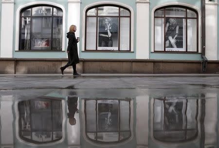 A woman walks along Stoleshnikov Lane, one of the city most expensive shopping areas accommodating numerous boutiques and luxury shops, in central Moscow, March 20, 2015. REUTERS/Maxim Zmeyev/Files
