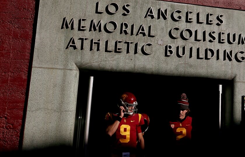 LOS ANGELES, CALIF. - OCT. 9, 2021. USC quarterbacks Kedon Slovis, left, and Jaxson Dart emerge from the locker room before the game against Utah at the Los Angeles Memorial Coliseum on Saturday, Oct. 9, 2021. (Luis Sinco / Los Angeles Times)