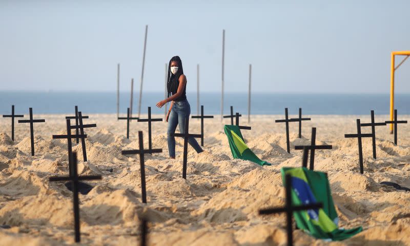 An activist of the NGO Rio de Paz wearing a protective mask attends a demonstration during which one hundred graves were dug on Copacabana beach symbolising the dead from the coronavirus disease (COVID-19), in Rio de Janeiro