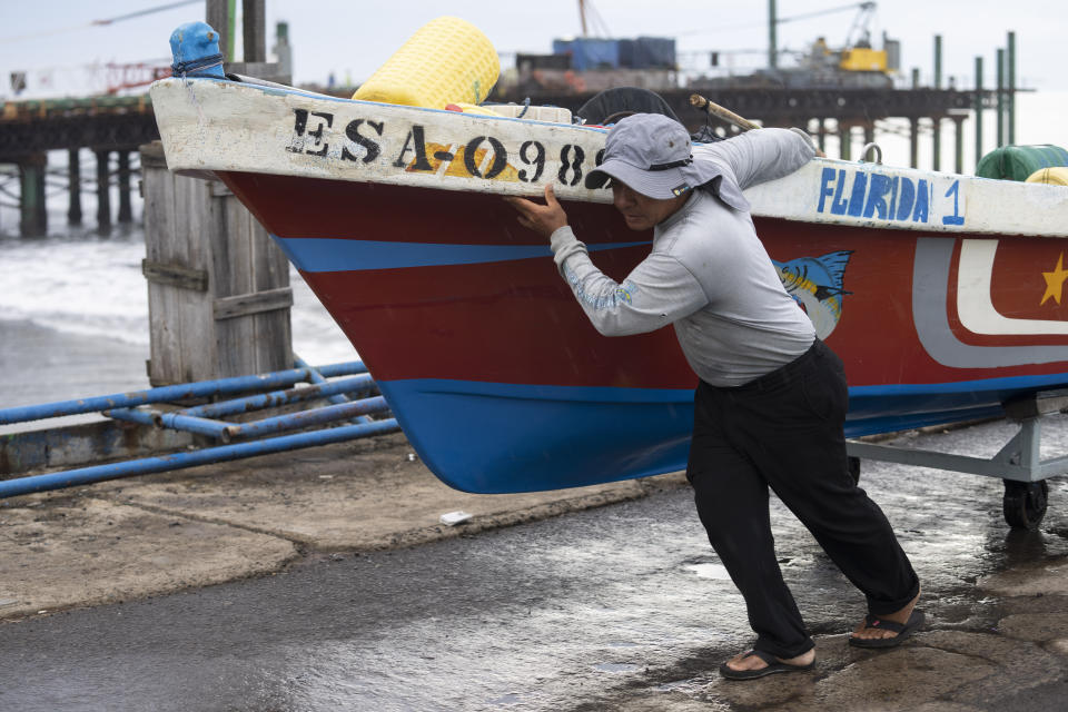 A fisherman secures a boat, preparing for the arrival of Hurricane Julia in La Libertad, El Salvador, Sunday, Oct. 9, 2022. Hurricane Julia hit Nicaragua’s central Caribbean coast after lashing Colombia’s San Andres island, and a weakened storm was expected to emerge over the Pacific. (AP Photo/Moises Castillo)