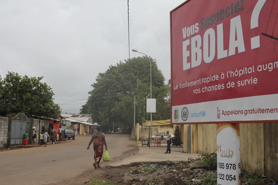 A billboard with a message about Ebola is seen on a street in Conakry, Guinea October 26, 2014. The U.S. Ambassador to the United Nations, Samantha Power, is traveling to Guinea on Sunday and will also visit Liberia and Sierra Leone, making the trip despite calls by some U.S. lawmakers for a travel ban on the three West African countries worst-affected by Ebola. REUTERS/Michelle Nichols (GUINEA - Tags: HEALTH POLITICS)