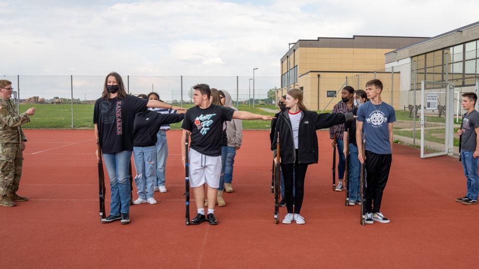 Spc. Garrett Nussbaumer, assigned to the 1st Battalion, 214th Aviation Regiment, guides JROTC cadets on the courts at Ansbach Middle High School, Germany, May 2, 2022. (Cpt. Gabrielle Hildebrand/Army)