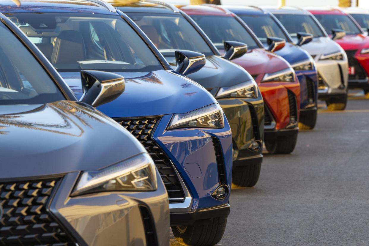 Sitges, Spain - 26th February, 2019: Lexus UX (Toyota Group) SUV vehicles in hybrid version parked on public parking before the drives. The UX model is the smallest crossover in the Lexus offer. Focus on a second car.