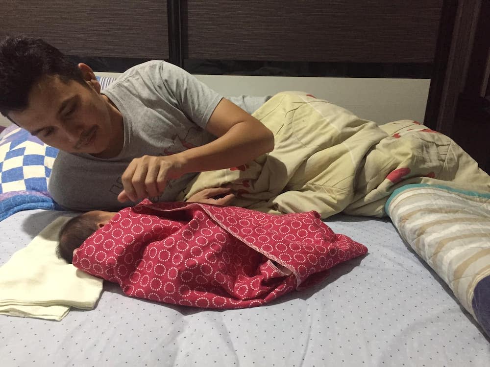 Fahmi Jamil laying down peacefully next to his second child, Fatihah. — Picture via Facebook/Fahmi Jamil